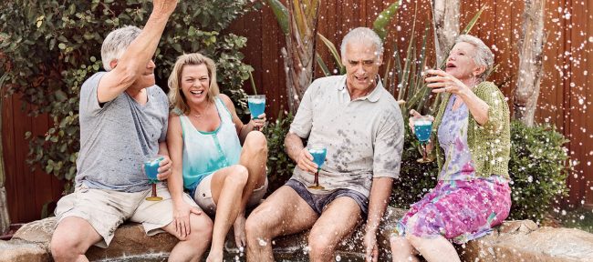 Group of seniors splashing in the hot tub