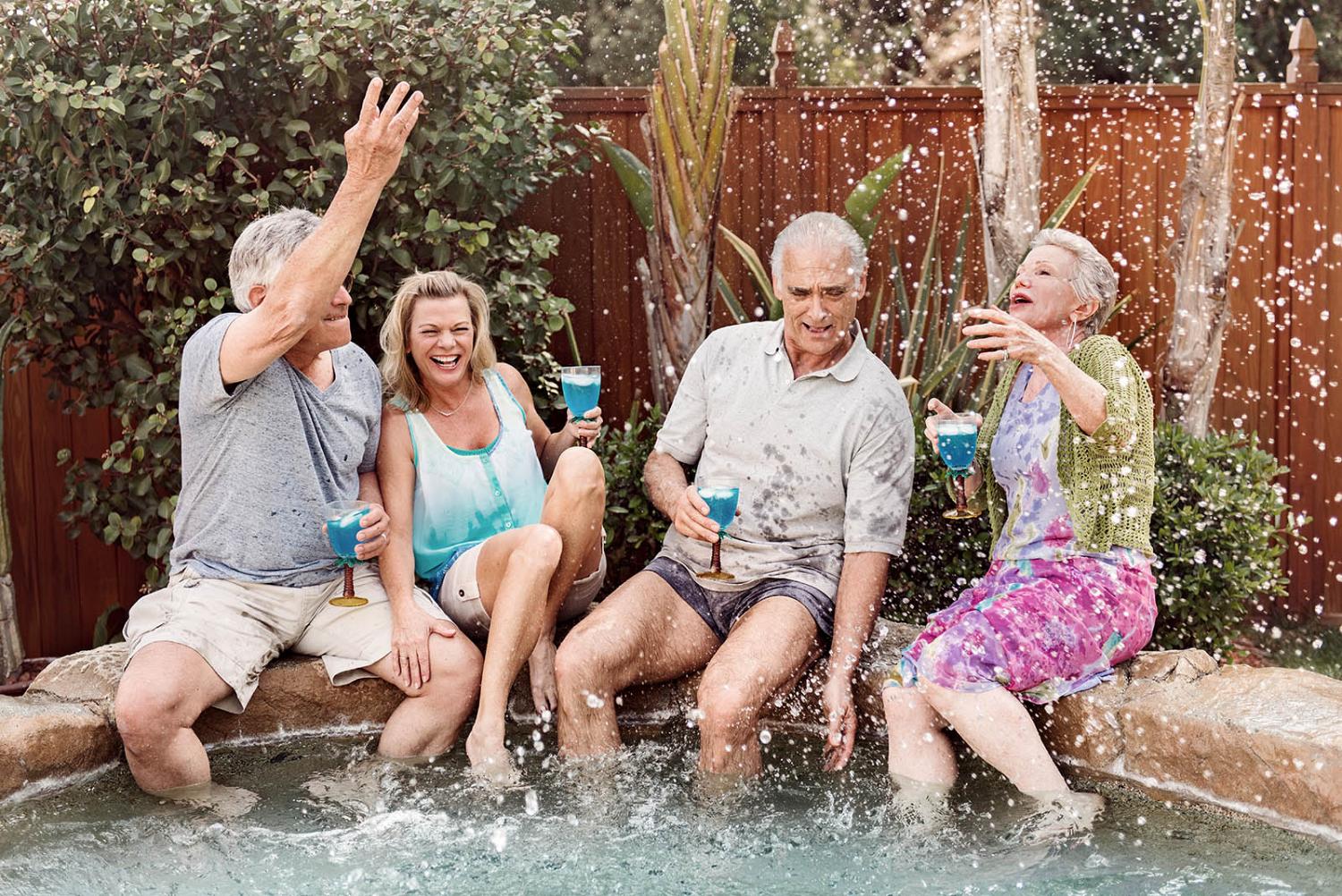 Group of seniors splashing in the hot tub