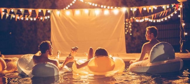 Night time pool and hot tub movie party