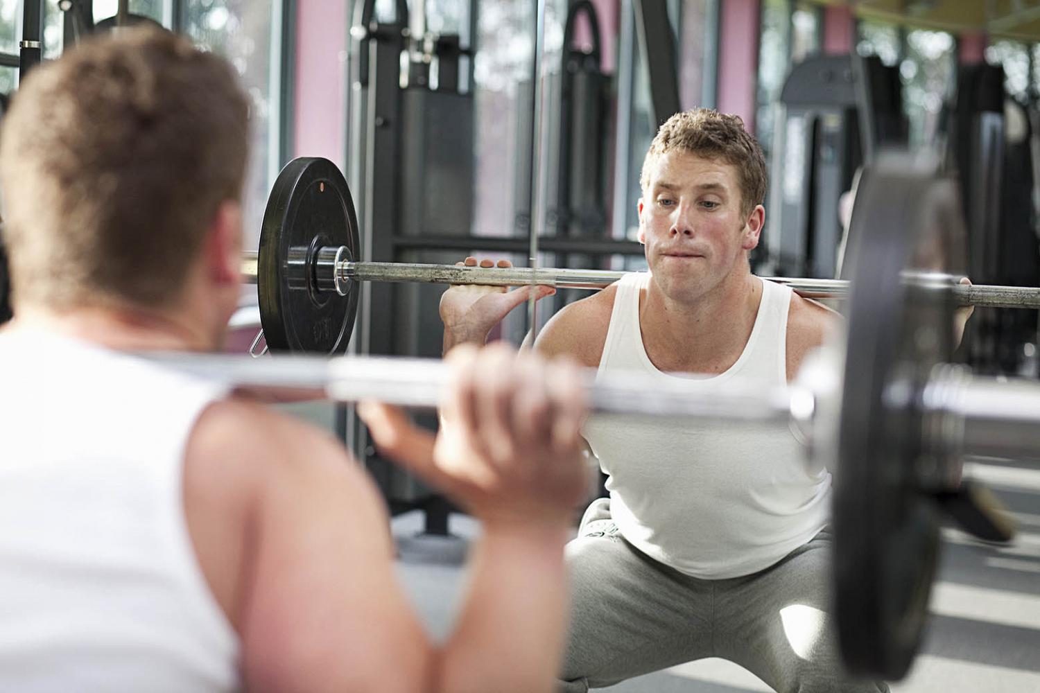 Man in gym lifting weights