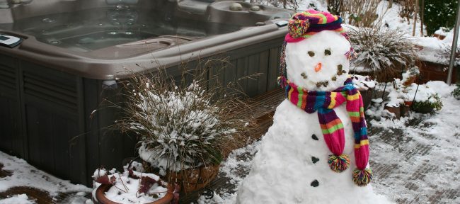 Hot tub spa outside with a snowman next to it