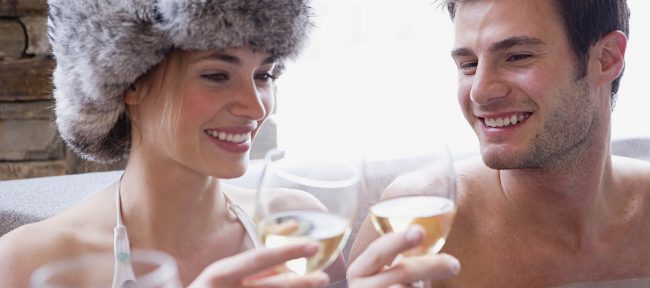 Couple in hot tub with wine