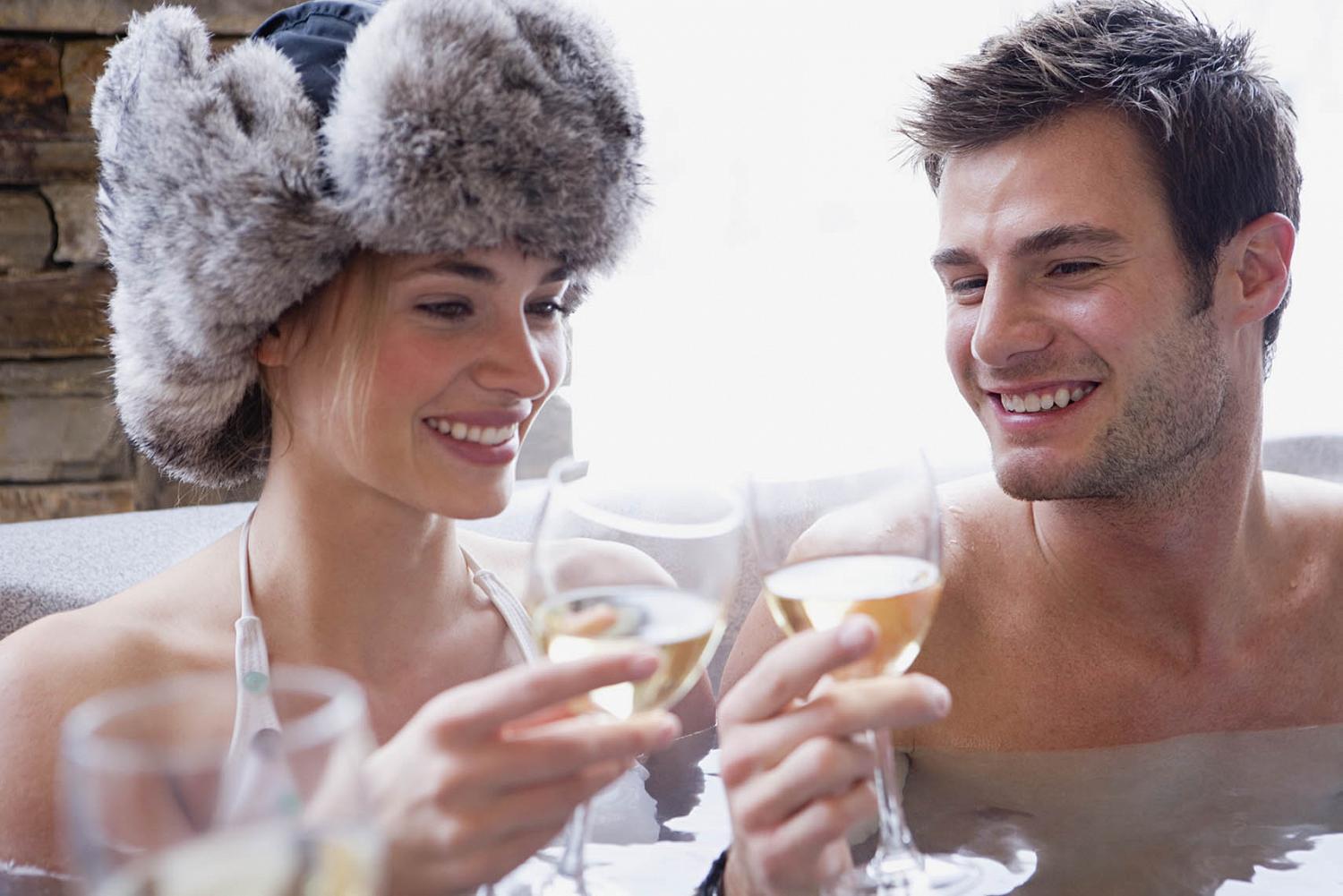 Couple in hot tub with wine