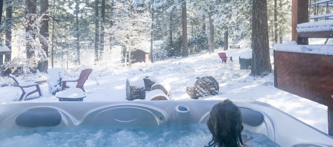 person-in-hot-tub-in-winter