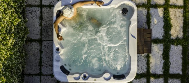 Man relaxing in a ph balanced hot tub